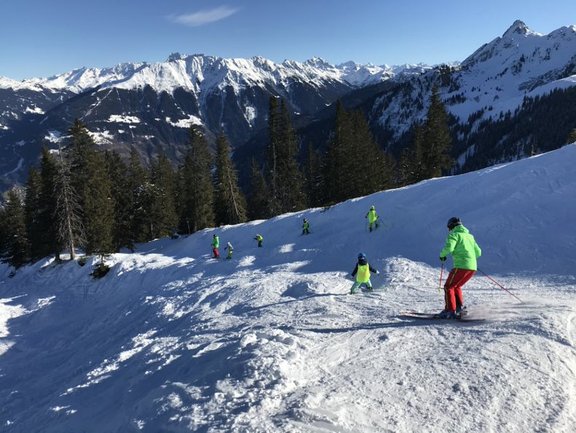 ein sich in der Abfahrt befindender Skifahrer